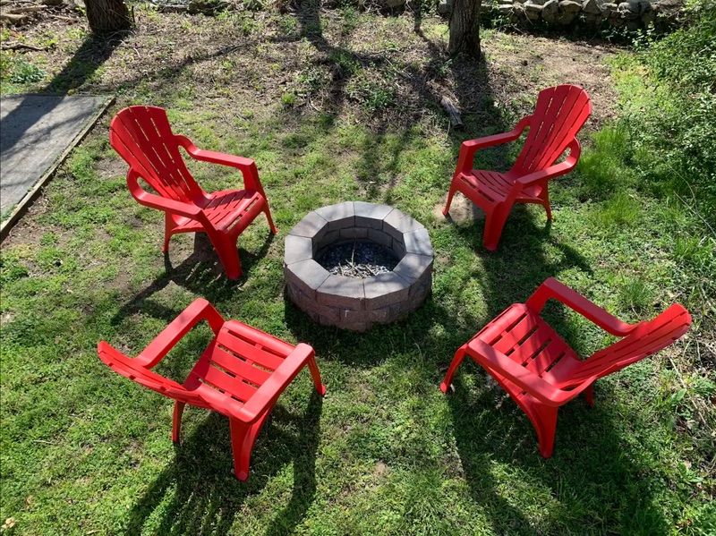 Shared fire pit area with red chairs