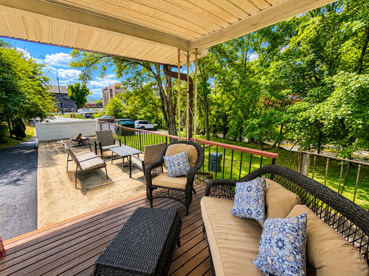 Private deck with wicker seating overlooking the river